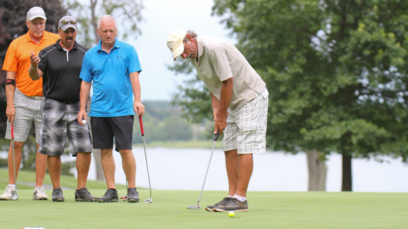 Steve Richman sinks a putt on  No. 18 at The Lake Club in Poland as from left Blase Cindric, Scott Russell and Doug Bleggi look on during Greatest Golfer Scramble championship.
