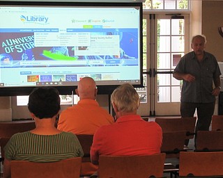 Neighbors | Jessica Harker .Librarian Tim Seman used the research tools on the library website to teach community members how to research fallen soliders July 25.