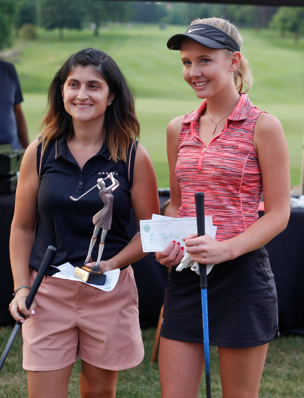 Felicia Drevna, left, and Jenna Jacobson pose after the long drive at Tippecanoe Country Club on Thursday night. Drevna came in first and Jacobson came in second. EMILY MATTHEWS | THE VINDICATOR