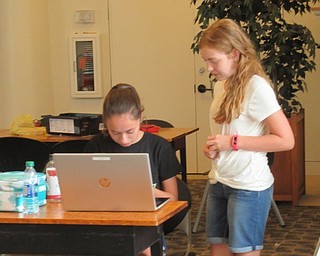 Neighbors | Jessica Harker .Josie Bishara and Joy Mohr work to program a robot at Tech Corp's first Techie Camp at the Austintown library designed for middle school students on Aug. 8.
