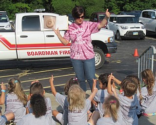 Neighbors | Jessica Harker .Volunteers read to children about the importance of fire alarms at Boardman's annual Safety Village day outside of Glenwood Junior High School.