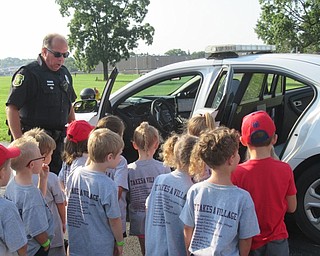 Neighbors | Jessica Harker .Boardman School Resource Officers allowed children to sit in a police car at the districts annual Safety Village Day.