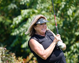 Pam Porter watches her drive during the final day of the Greatest Golfer tournament at the Lake Club on Sunday. EMILY MATTHEWS | THE VINDICATOR