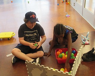 Neighbors | Jessica Harker .Children counted the balls they collected, tallying up their team score during the Michael Kusalaba library's Hungry Hungry Sharks game on July31.