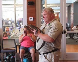 Neighbors | Jessica Harker .Mark Kohlhorst held a small alligator July 29 at the Michael Kusalaba library for his live animal show.