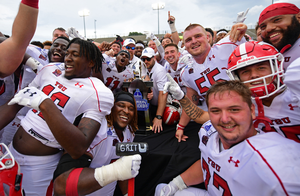 MONTGOMERY, ALABAMA - AUGUST 24, 2019: Members of the Youngstown State football team celebrate with the trophy after defeating Samford, Saturday afternoon. DAVID DERMER | THE VINDICATOR