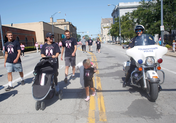 Youngstown Police Officer Bob Dimaiolo encourages his daughter Remy Dimaiolo, 3, to finish the two mile walk with, from left, Zach Stouffer, Jen Dimaiolo, and Ethan Overly, all of whom were walking in memory of Donna Yancsurak, during the 2019 Panerathon on Sunday morning. EMILY MATTHEWS | THE VINDICATOR