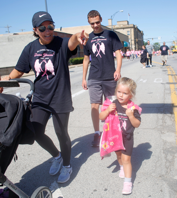 From left, Jen Dimaiolo, Ethan Overly, and Remy Dimaiolo, all of whom were walking in memory of Donna Yancsurak, walk down Front Street as they near the finish of the two mile walk during the 2019 Panerathon on Sunday morning. EMILY MATTHEWS | THE VINDICATOR