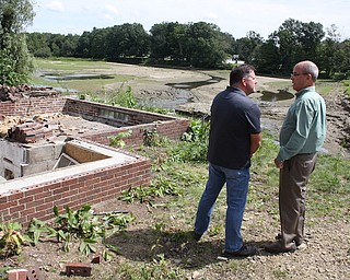 Randy Smith, Trumbull County Engineer, left, and state Rep. Michael O'Brien stand near the home being demolished and the area where the Kinsman Lake causeway washed away July 20. There was a news conference Monday morning to announce the the start of repairs on the causeway.