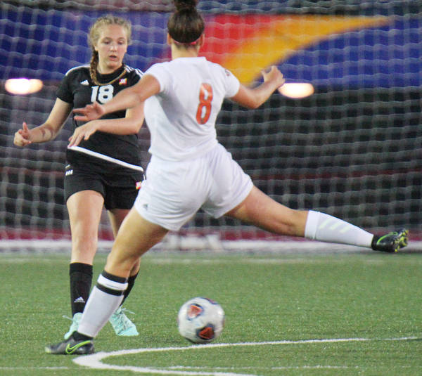 William D. Lewis the vindicator  Howland's Olivia Myers(8) kicks around Mooney's Keelee Torma(18) during 8-28-19 action at YSU.