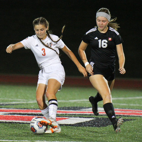 William D. Lewis The Vindicator Howland's Ashley Chamber's(3) moves the ball past Mooney's Ava Szaly(16) during 8-28-19 action at YSU.