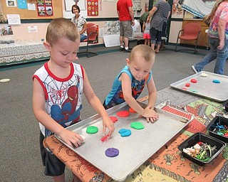 Neighbors | Jessica Harker .Jackson and Shane Seddon are pictured playing in play dough on Aug. 4 at the Mill Creek MetroParks Farms Nature Live! event.
