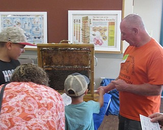 Neighbors | Jessica Harker .Bee Keeper Don Kovach showed community members some of his bees at the MetroParks Farms Nature Live! event on Aug. 4.