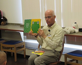 Neighbors | Jessica Harker .Librarian John Yingling read to children gathered at Boardman library's weekly Baby Brilliant event August 6.