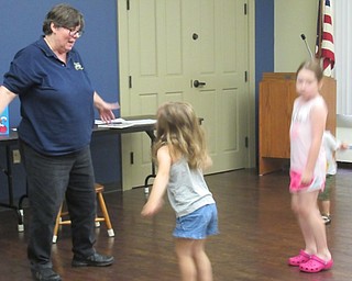 Neighbors | Jessica Harker.Children danced like kangaroos with librarian Karen Saunders at the Boardman library August 7.