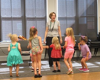 Neighbors | Jessica Harker .Librarian Nikki Puhalla danced with children at the Canfield library's Read and Make event.