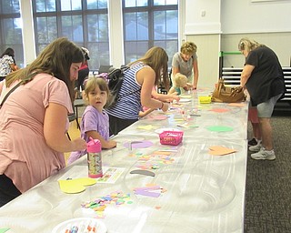 Neighbors | Jessica Harker .Children and their families worked on creating a shape monster at the Canfield library on Aug. 14 for the weekly Read and Make event.