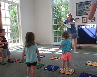 Neighbors | Jessica Harker .Toddlers danced along with Librarian Vicky Puhalla as she sang butterfly themed songs at the Poland library on Aug. 15.