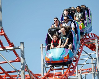 People ride the roller coaster at the Canfield Fair on Thursday. EMILY MATTHEWS | THE VINDICATOR