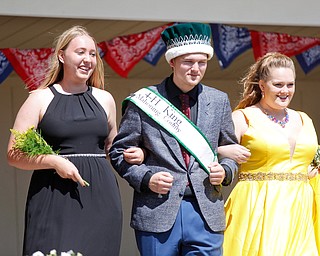Natalia Kresic, left, of Lordstown, and Cheyenne Heffner, right, of Springfield, are escorted by last year's 4-H king Matthew Fetty before the crowning of this year's king and queen during the Mahoning County Junior Fair Youth Day Ceremony on Thursday. Kresic was crowned this year's queen. EMILY MATTHEWS | THE VINDICATOR