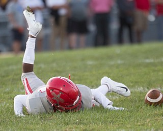 Chaney's Joe Kordupel falls to the ground after missing the ball during their game against Cardinal Mooney at Rayen Stadium on Thursday. EMILY MATTHEWS | THE VINDICATOR