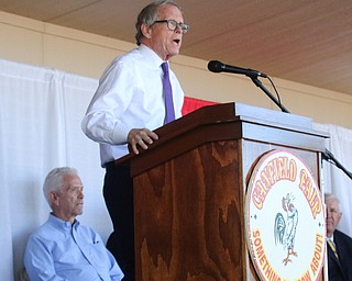         ROBERT K.YOSAY  | THE VINDICATOR..The 173rd version of the Canfield Fair official ribbon cutting as Fred Moran 84 jumped from the plane to help publicize Veterans Jobs.Mike DeWine talks about the Canfield Fair