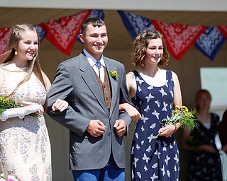 Emily Fagert, left, of Springfield, and Nataley Kremmer, of South Range, are escorted by James Moore, of South Range, before the crowning of this year's 4-H king and queen during the Mahoning County Junior Fair Youth Day Ceremony on Thursday. Moore was crowned this year's 4-H king. EMILY MATTHEWS | THE VINDICATOR