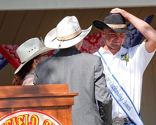 Thomas Kemp, of West Branch, puts on his winning hat as he is named one of this year's Outstanding Youth during the Mahoning County Junior Fair Youth Day Ceremony on Thursday. EMILY MATTHEWS | THE VINDICATOR